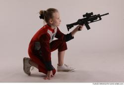 DENISA KNEELING POSE WITH GUN